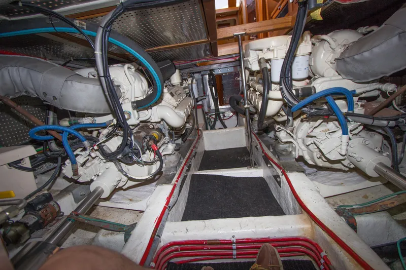 Slide: The Image of Engine room of a 1992 Offshore Yachts Sedan, showcasing dual engines and wiring. - 34