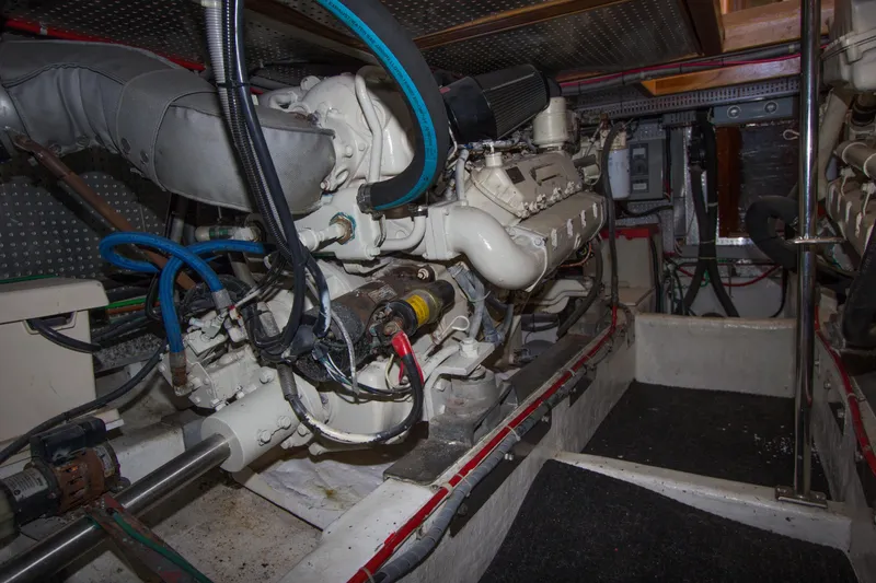 Slide: The Image of Engine room of a 1992 Offshore Yachts Sedan, showcasing mechanical components and wiring. - 36