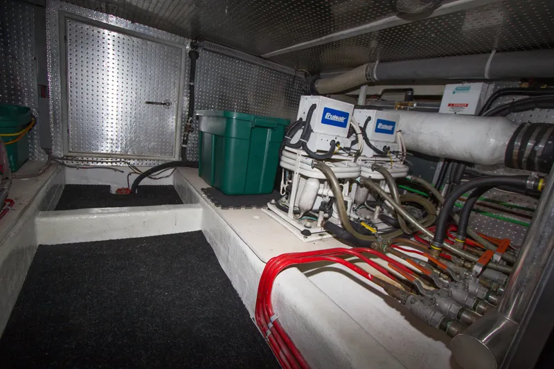 Slide: The Image of Engine room of a 1992 Offshore Yachts Sedan with mechanical equipment and wiring. - 37