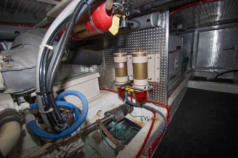 Slide: The Image of Engine room of a 1992 Offshore Yachts Sedan, featuring fuel filters and fire extinguisher. - 39
