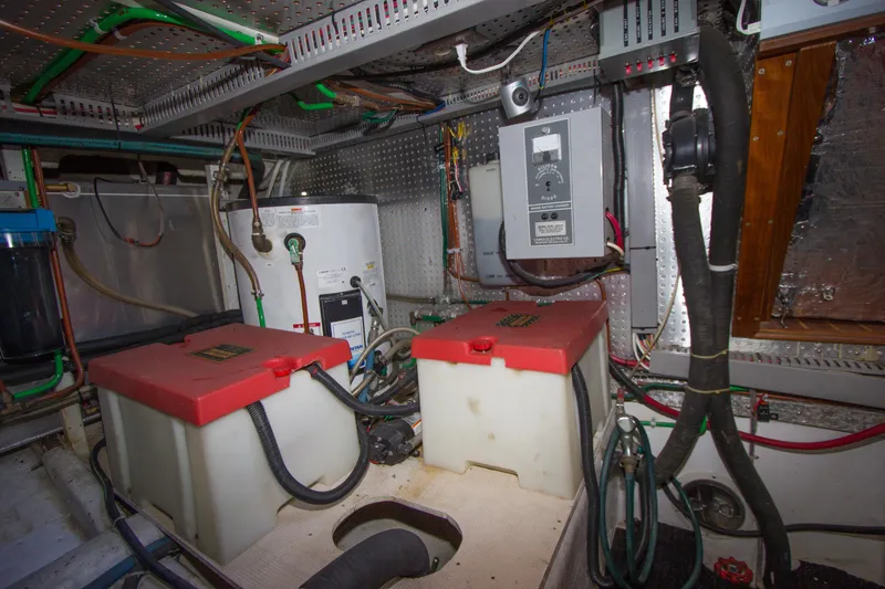Slide: The Image of Engine room of a 1992 Offshore Yachts Sedan, featuring batteries and electrical systems. - 41