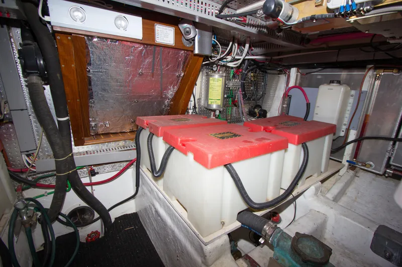 Slide: The Image of 1992 Offshore Yachts Sedan engine room with batteries and wiring. - 42