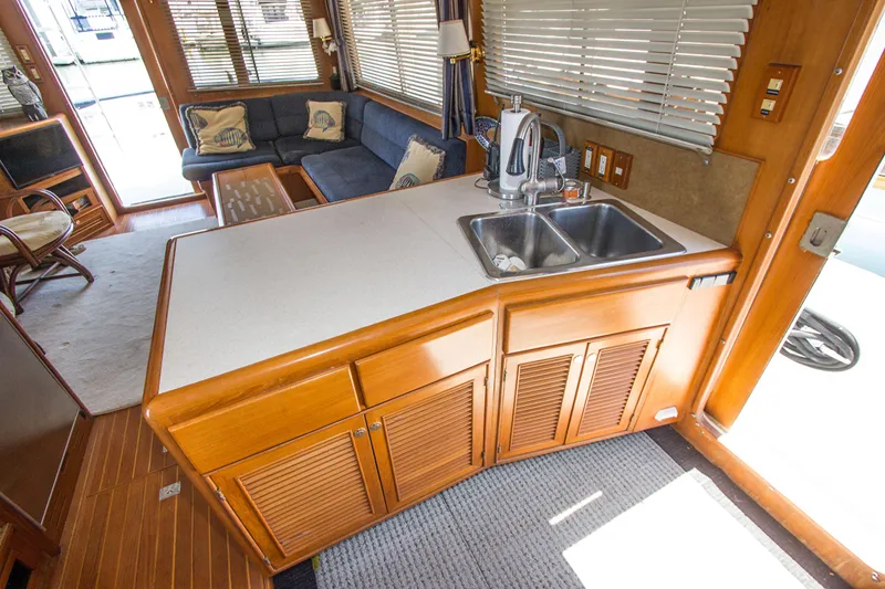 Slide: The Image of Interior of 1992 Offshore Yachts Sedan with kitchen sink and cozy seating area. - 8
