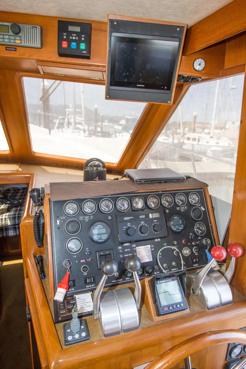 Slide: The Image of 1992 Offshore Yachts Sedan helm with control panel and navigation instruments. - 10