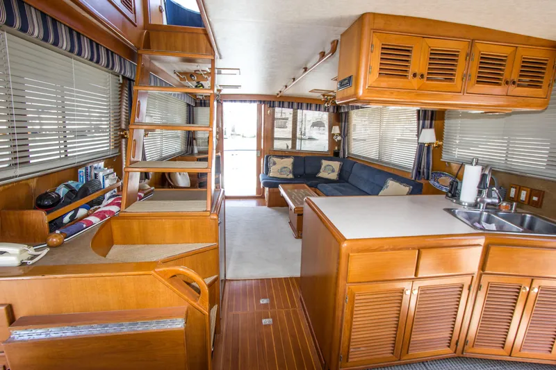 Slide: The Image of Interior of a 1992 Offshore Yachts Sedan with wooden cabinetry and cozy seating area. - 2