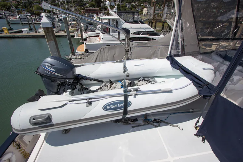 Slide: The Image of 1992 Offshore Yachts Sedan with inflatable dinghy and Yamaha motor at marina. - 24