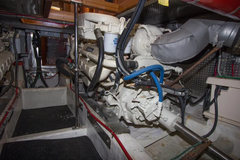 Slide: The Image of Engine room of a 1992 Offshore Yachts Sedan, showcasing mechanical components and wiring. - 35