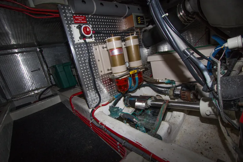 Slide: The Image of Engine room of a 1992 Offshore Yachts Sedan, showcasing mechanical components and wiring. - 40