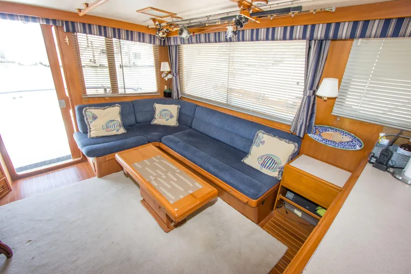 Slide: The Image of Interior of 1992 Offshore Yachts Sedan with blue seating and wooden accents. - 5