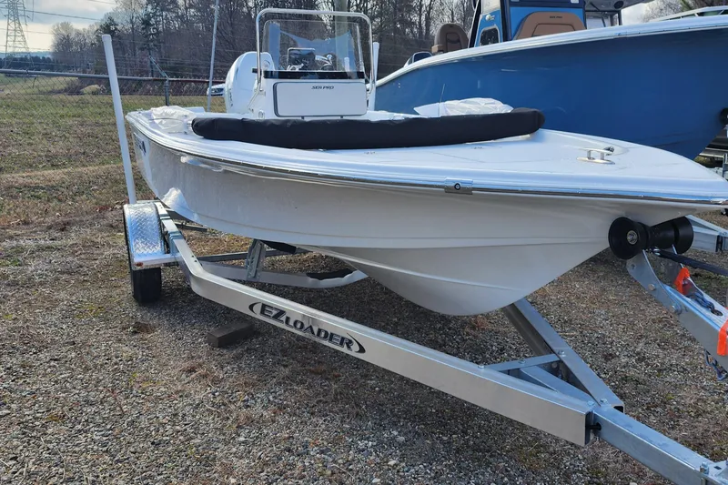 Slide: The Image of 2025 Sea Pro 172 Bay boat on EZ Loader trailer, parked outdoors. - 10