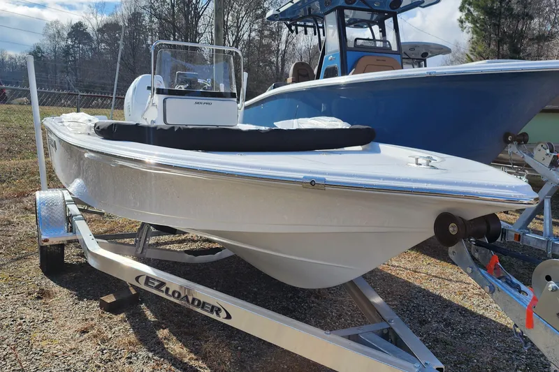 Slide: The Image of 2025 Sea Pro 172 Bay boat on EZ Loader trailer, parked outdoors. - 13