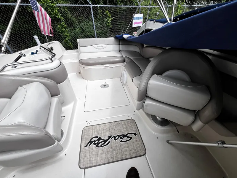Slide: The Image of 2004 Sea Ray 240 Sundeck interior with seating and American flag. - 13
