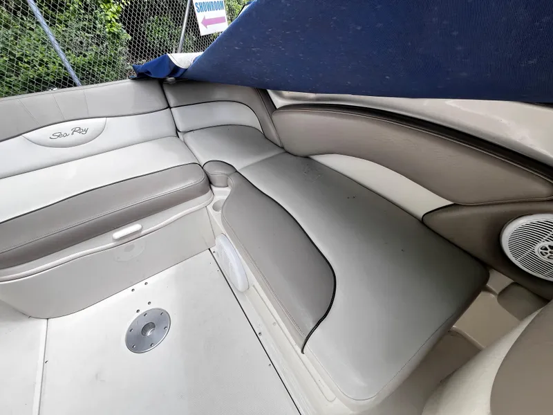 Slide: The Image of 2004 Sea Ray 240 Sundeck interior with beige seating and speaker. - 14