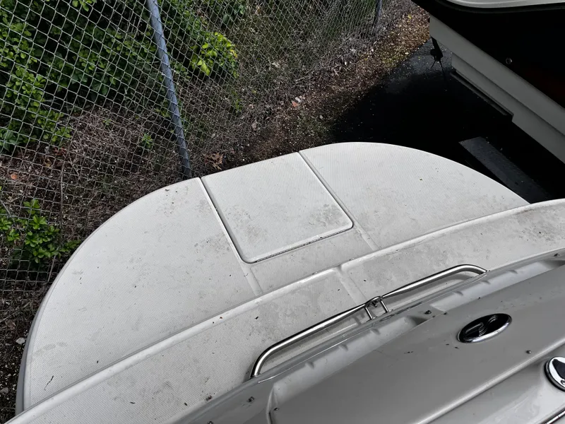 Slide: The Image of 2004 Sea Ray 240 Sundeck swim platform with textured surface and railing. - 17