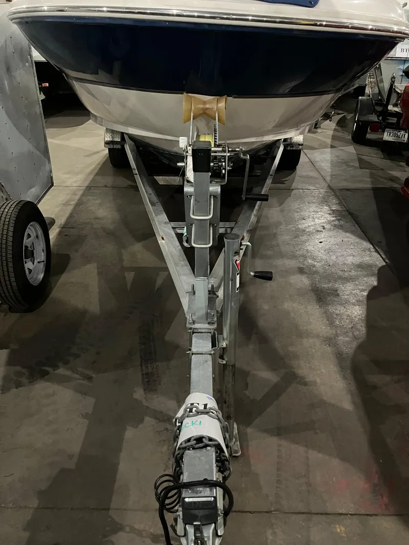Slide: The Image of 2004 Sea Ray 240 Sundeck on trailer in indoor storage facility. - 18