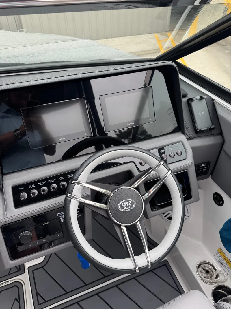 Slide: The Image of 2023 Cobalt R4 boat dashboard with modern steering wheel and dual display screens. - 15