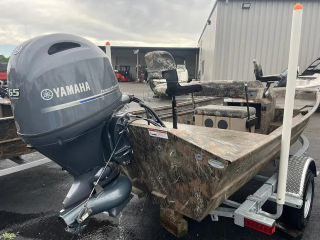 Slide: The Image of 2023 G3 17 CCJ boat with Yamaha outboard motor on trailer, parked outdoors. - 3