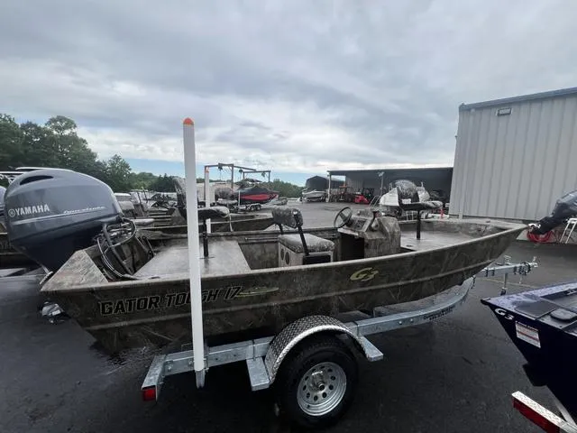 Slide: The Image of 2023 G3 17 CCJ boat on trailer, parked outdoors near other boats. - 4
