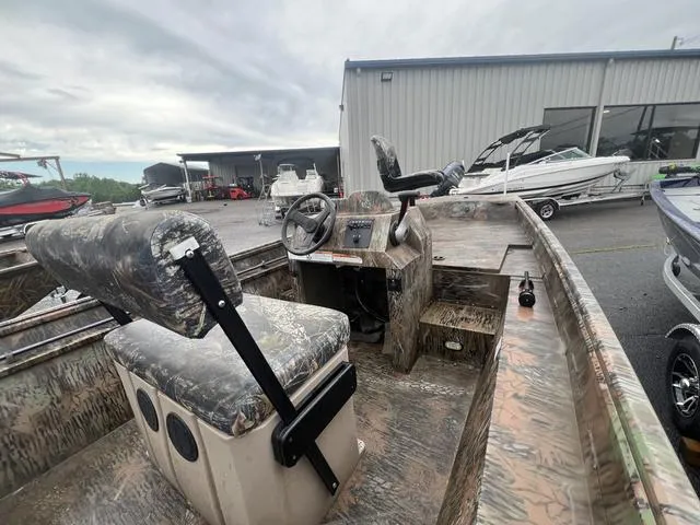 Slide: The Image of Camouflage-patterned 2023 G3 17 CCJ boat interior with steering console and seating. - 5