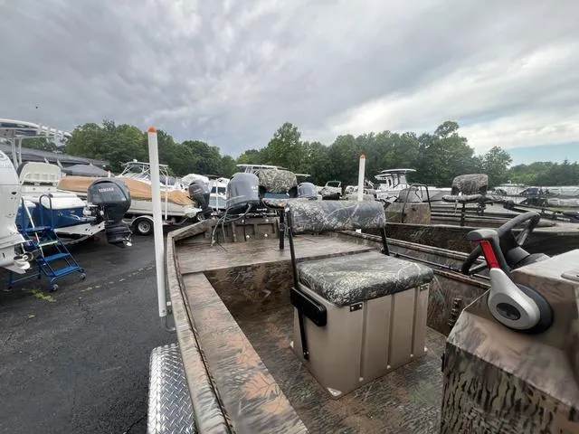 Slide: The Image of 2023 G3 17 CCJ boat in a lot, featuring camo seats and steering wheel. - 7