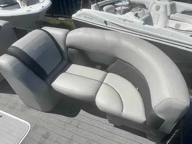 Slide: The Image of Luxurious seating on 2022 Sylvan Mirage X3 Tri Toon boat, featuring sleek gray upholstery. - 12