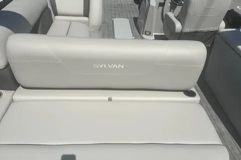 Slide: The Image of 2022 Sylvan Mirage X3 Tri Toon boat interior with white seating and steering console. - 13