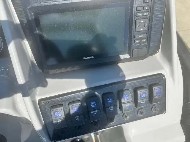 Slide: The Image of Control panel of 2022 Sylvan Mirage X3 Tri Toon with Garmin display and switches. - 6