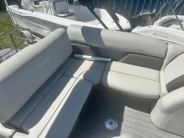 Slide: The Image of 2022 Sylvan Mirage X3 Tri Toon boat with comfortable seating and modern design. - 9