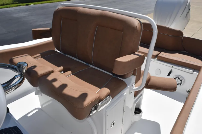 Slide: The Image of 2025 Sea Hunt Ultra 245 SE boat with brown cushioned seating and white railing. - 11
