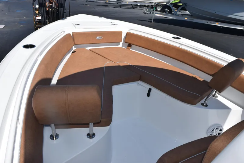 Slide: The Image of 2025 Sea Hunt Ultra 245 SE boat interior with brown cushioned seating. - 12