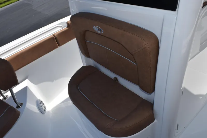 Slide: The Image of 2025 Sea Hunt Ultra 245 SE boat with brown cushioned seating. - 13