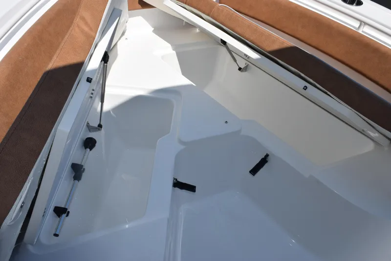 Slide: The Image of 2025 Sea Hunt Ultra 245 SE boat interior with white deck and brown seating. - 15