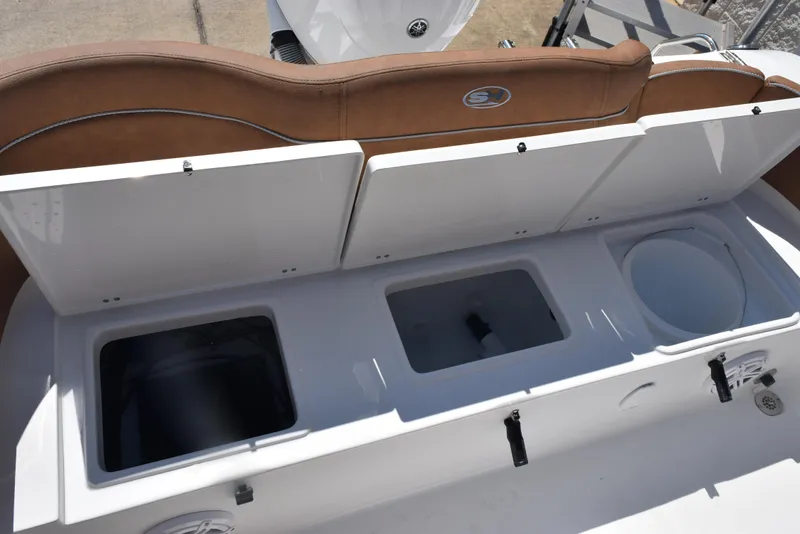 Slide: The Image of 2025 Sea Hunt Ultra 245 SE boat storage compartments with brown seating. - 20