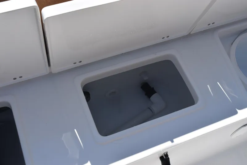 Slide: The Image of Storage compartment on 2025 Sea Hunt Ultra 245 SE boat, featuring clean white interior. - 22