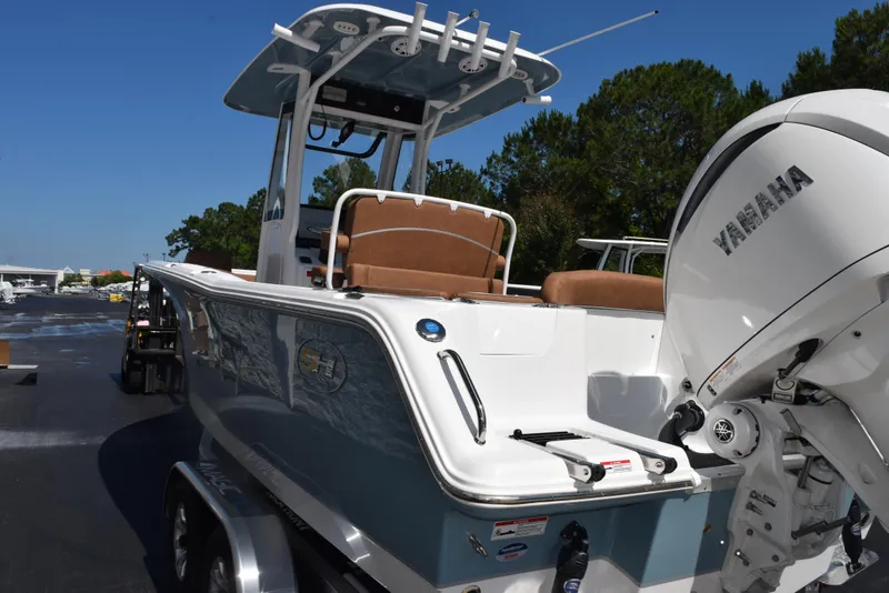 Slide: The Image of 2025 Sea Hunt Ultra 245 SE boat with Yamaha engine, parked outdoors. - 5