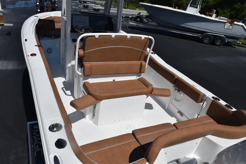 Slide: The Image of 2025 Sea Hunt Ultra 245 SE boat with brown seating and white deck. - 6
