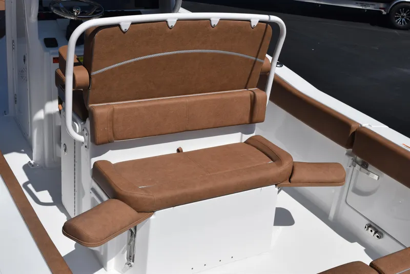 Slide: The Image of 2025 Sea Hunt Ultra 245 SE boat interior with brown cushioned seating. - 7