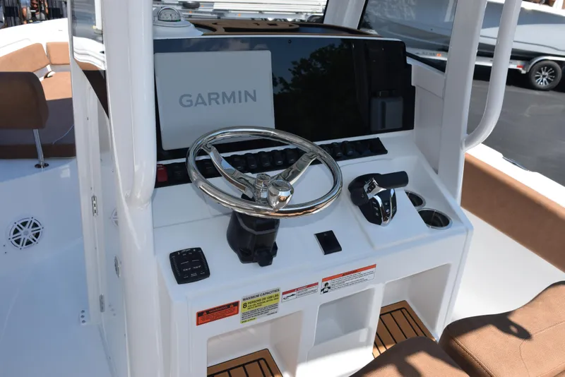 Slide: The Image of 2025 Sea Hunt Ultra 245 SE boat console with Garmin navigation system and steering wheel. - 9