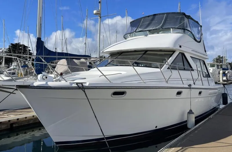 Slide: The Image of 2000 Bayliner 3988 yacht docked at marina under clear blue sky. - 17