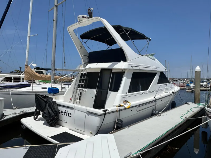 Slide: The Image of 2000 Bayliner 3988 yacht docked at marina under clear blue sky. - 18
