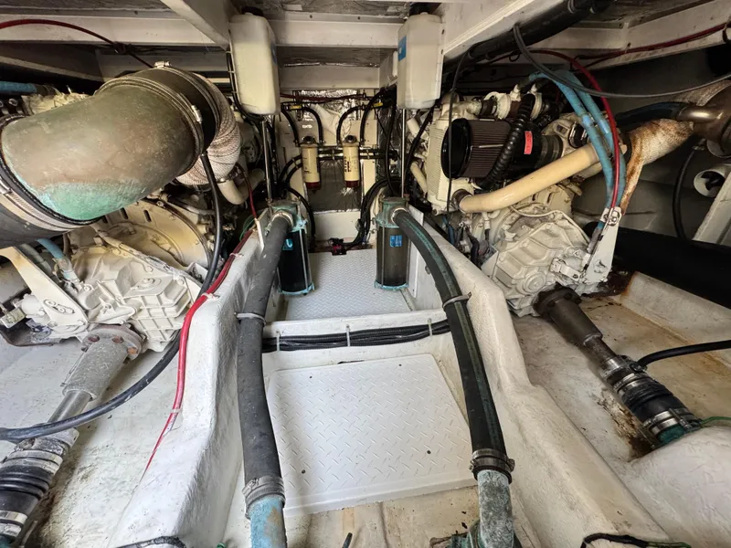 Slide: The Image of Engine room of a 2000 Bayliner 3988, showcasing dual engines and mechanical components. - 21