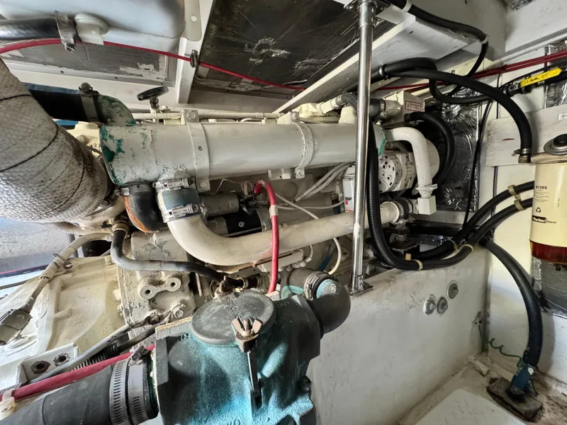 Slide: The Image of Engine room of a 2000 Bayliner 3988 boat, showcasing mechanical components and piping. - 22