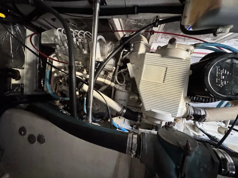 Slide: The Image of Engine compartment of a 2000 Bayliner 3988 boat, showcasing mechanical components and wiring. - 23