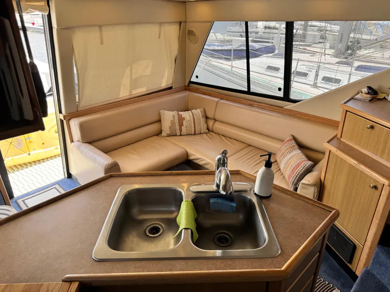 Slide: The Image of Interior of 2000 Bayliner 3988 yacht with kitchen sink and cozy seating area. - 32