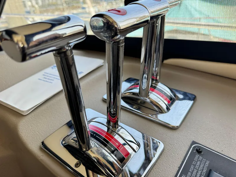 Slide: The Image of Chrome throttle controls on a 2000 Bayliner 3988 yacht dashboard. - 33