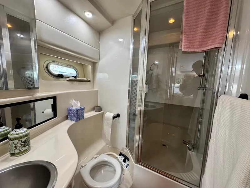 Slide: The Image of Bayliner 3988 2000 yacht bathroom with shower, sink, and porthole window. - 37