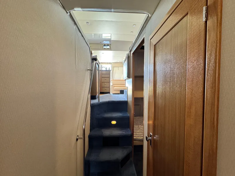 Slide: The Image of Interior hallway of 2000 Bayliner 3988 yacht with carpeted stairs and wooden door. - 40