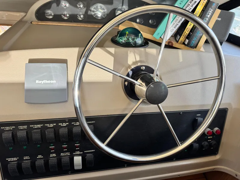 Slide: The Image of Steering wheel and controls of a 2000 Bayliner 3988 boat cockpit. - 42