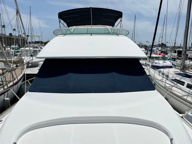 Slide: The Image of Bayliner 3988 yacht, 2000 model, docked in marina with sailboats in background. - 49