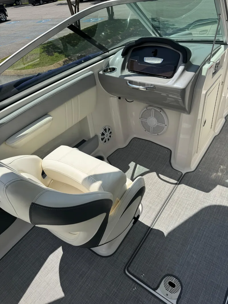 Slide: The Image of 2022 Chaparral 21 SSi boat interior with helm, seat, and speaker. - 4